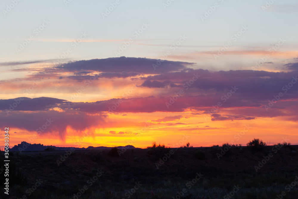 Vivid Desert Sunset with Silhouetted Landscape