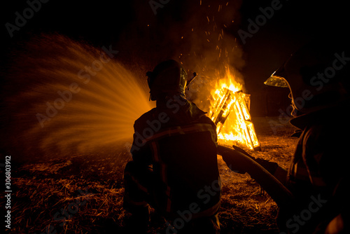 Firemen suppressing fire