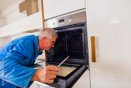 Handyman fixing the oven