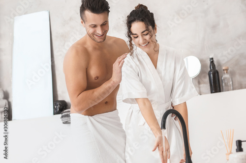 Happy young couple in bathr...