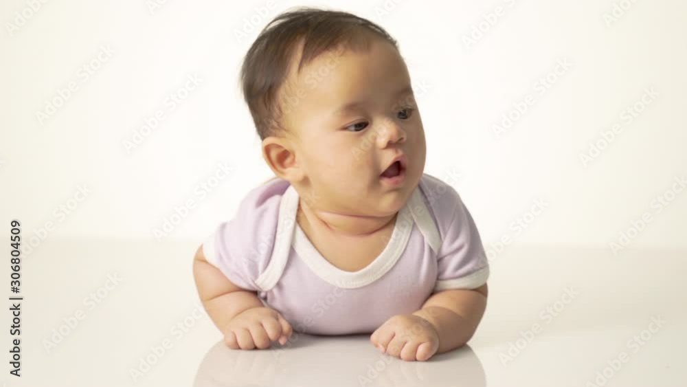 baby laying on her belly. tummy time cute baby in studio portrait baby laying on her belly. tummy time cute baby in studio portrait