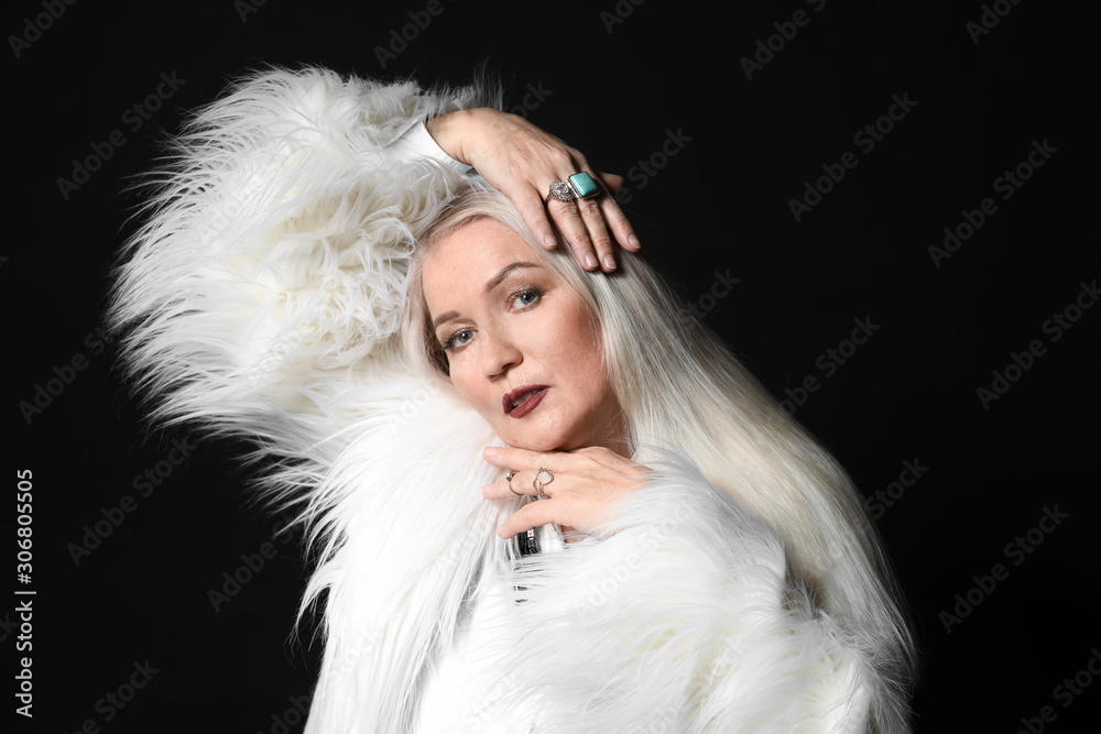 Fashionable mature woman on dark background Fashionable mature woman on dark background