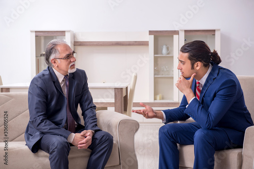 Two businessman discussing business in office