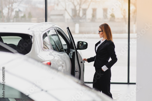 business woman in auto salon. concept of female driver © Serhii