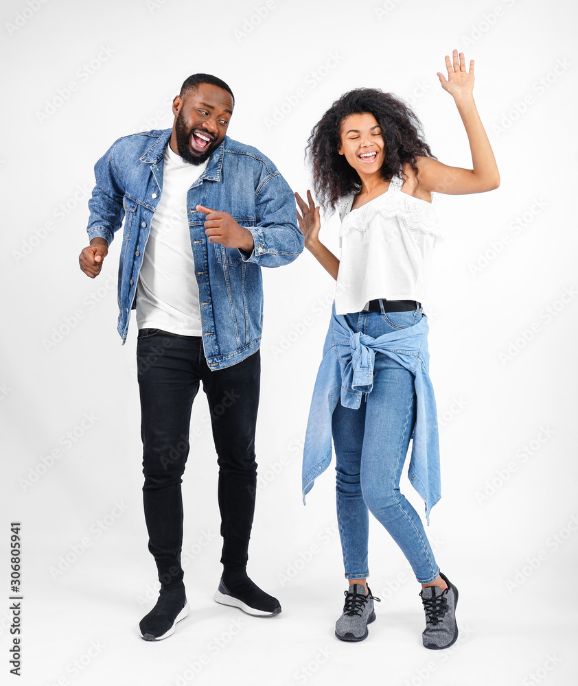 Portrait of young dancing African-American couple on white background Portrait of young dancing African-American couple on white background