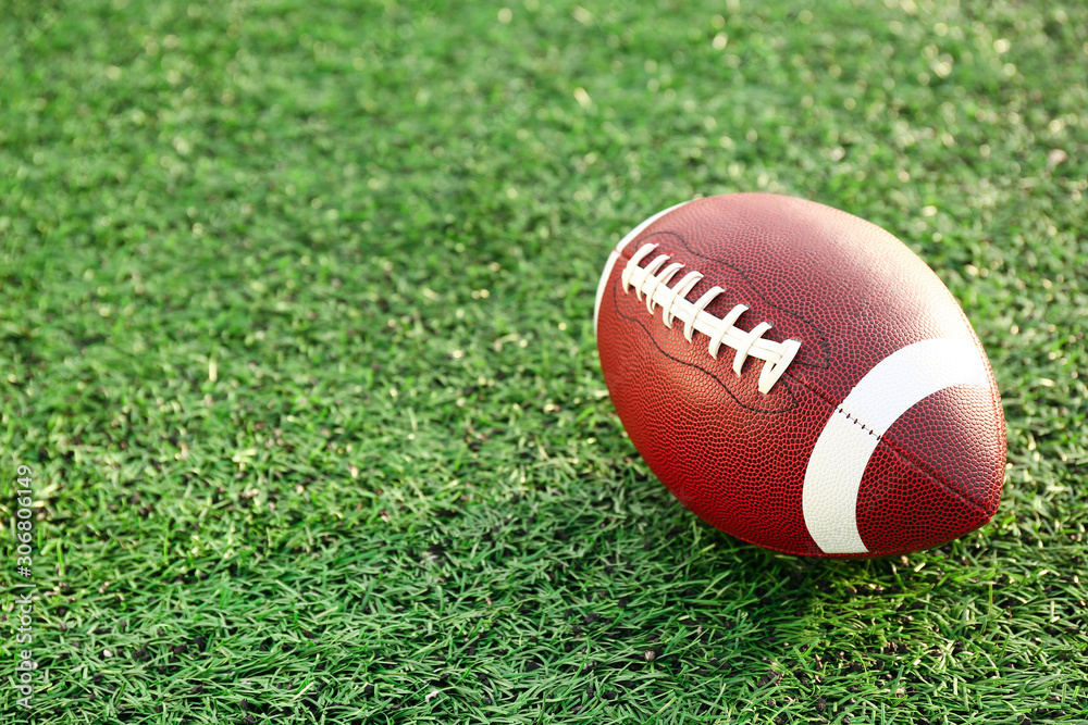 Rugby ball on green field outdoors Rugby ball on green field outdoors