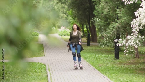 Wallpaper Mural Young woman is riding on rollerblades in the park Torontodigital.ca