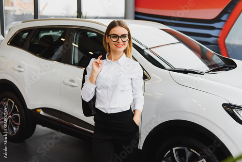 business woman in auto salon. concept of female driver