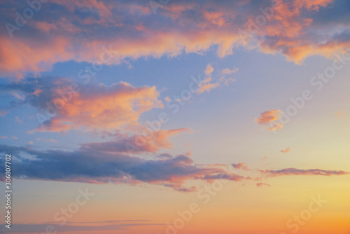 Beautiful twilight sunset sky and cloud at summer background image. New heaven light and earth concept. Dramatic sun ray with blue orange sky and pink purple clouds dawn texture color background.