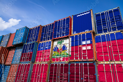 Cuadro en lienzo The national flag of Haiti on a large number of metal containers for storing goods stacked in rows on top of each other