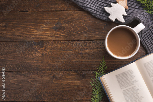 Christmas theme background with decorating elements, book and and Christmas tree on dark wood table. Creative Flat layout and top view composition