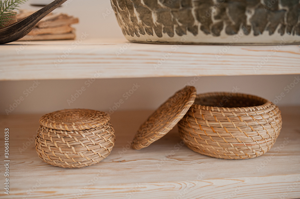 two woven straw baskets for storage in boho style