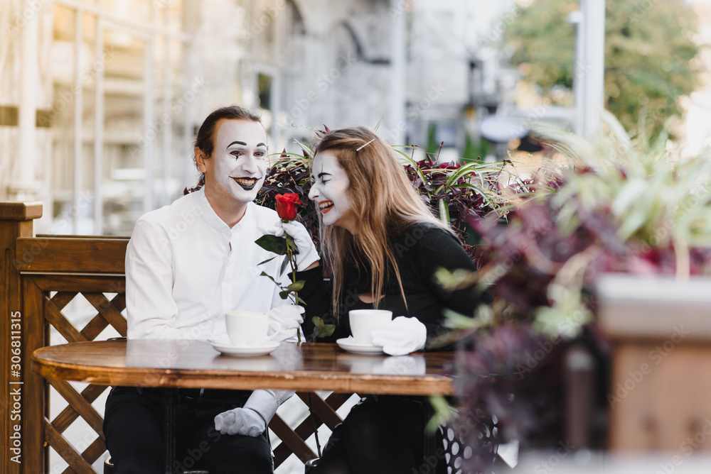 Mimes in front of Paris cafe acting like drinking tea or coffee. Mimes in front of Paris cafe acting like drinking tea or coffee.