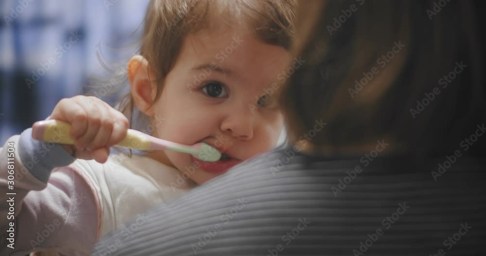 Funny little girl brushing her teeth. Shot in 4K RAW on a cinema camera. Funny little girl brushing her teeth. Shot in 4K RAW on a cinema camera.