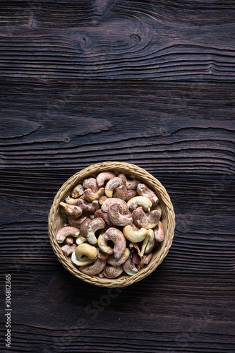 Roasted cashews on natural wooden table background