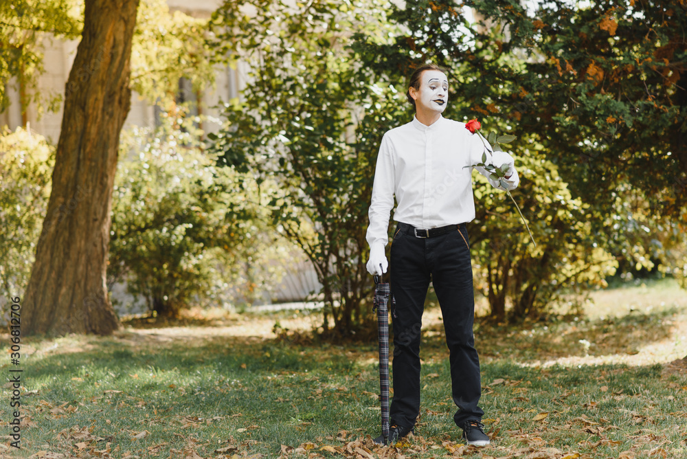 young Funny mime shows something.