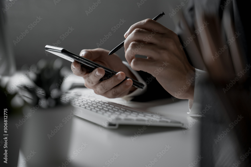 Close up shot of businessman working in office use smart phone Close up shot of businessman working in office use smart phone