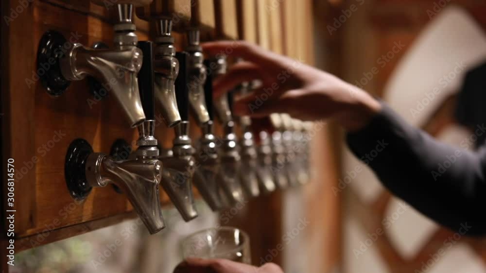Bartender pouring  beer into glass with bubbles close up 
