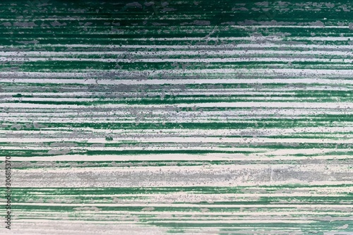 The white cement floor that is painted in green gives a straight line pattern