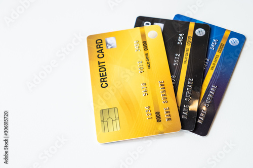 Close up of a set of cradit cards isolated on white background. Credit card lets cardholders borrow funds with which to pay for goods and services depend on the condition that cardholders pay back.