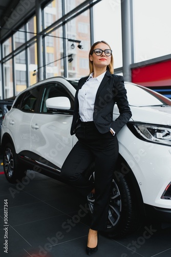 business woman buys a car at a car dealership © Serhii