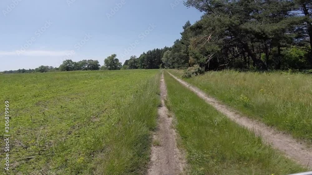 Cycling in rough terrain through a green meadow Cycling in rough terrain through a green meadow