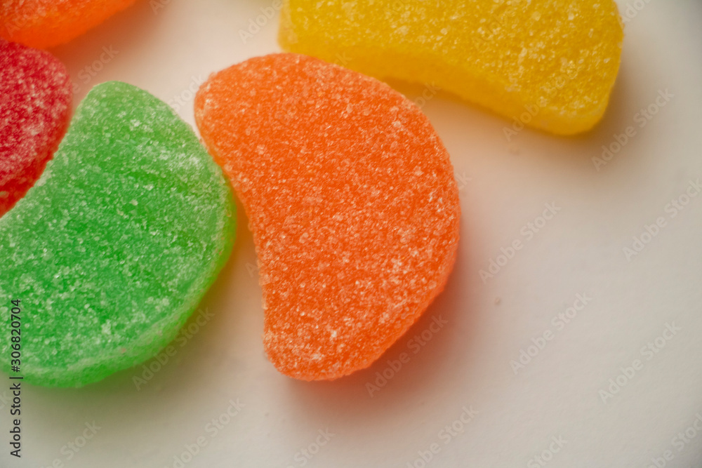 Isolated Jelly Fruit Slices Close Up Colorful candy used for decorating cookies, treats and gingerbread houses. Easter treat. Macro view. White background. Fun and sweet. Isolated Jelly Fruit Slices Close Up Colorful candy used for decorating cookies, treats and gingerbread houses. Easter treat. Macro view. White background. Fun and sweet.