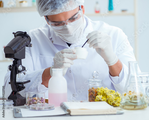 Chemist mixing perfumes in the lab