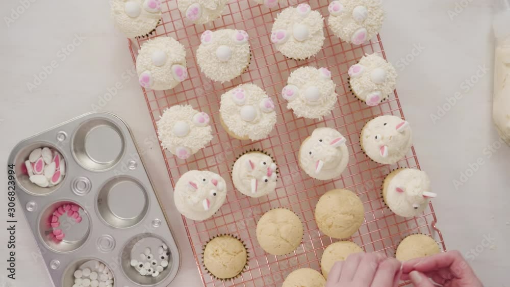 Time lapse. Flat lay. Step by step. Decorating vanilla cupcakes with white buttercream frosting for Easter. Time lapse. Flat lay. Step by step. Decorating vanilla cupcakes with white buttercream frosting for Easter.