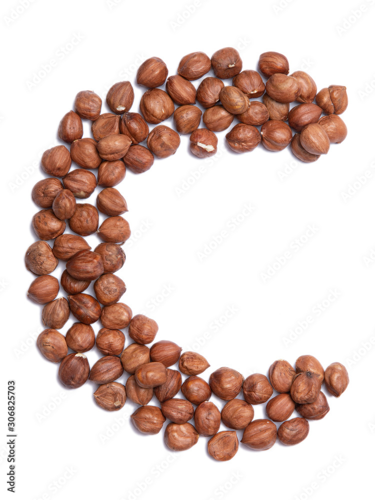 Letter C of the English alphabet from from hazelnut on a white isolated background. Food pattern made from nuts. Bright alphabet for shops. Letter C of the English alphabet from from hazelnut on a white isolated background. Food pattern made from nuts. Bright alphabet for shops.