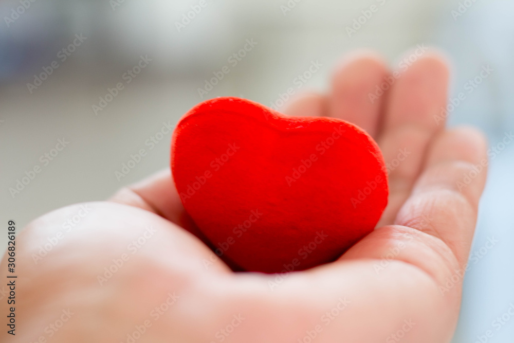 Holding a red heart Holding a red heart