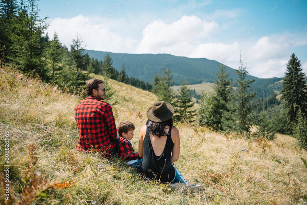 Young family with child resting on a mountain
