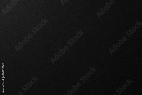 Black paper texture. Dark background with copyspace