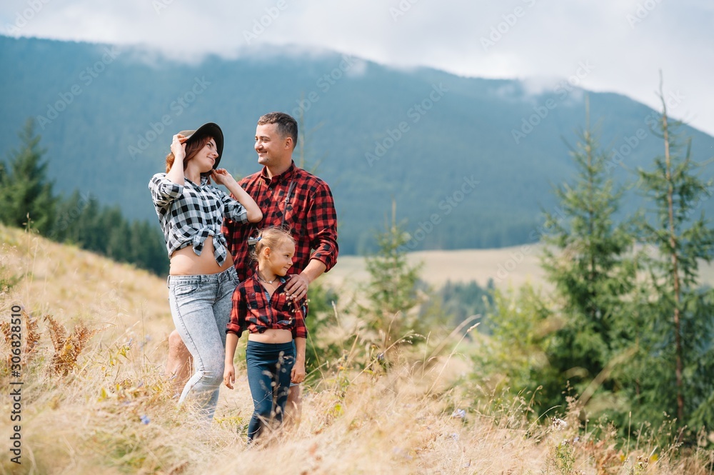Young family with child resting on a mountain. vacation in the national park Young family with child resting on a mountain. vacation in the national park