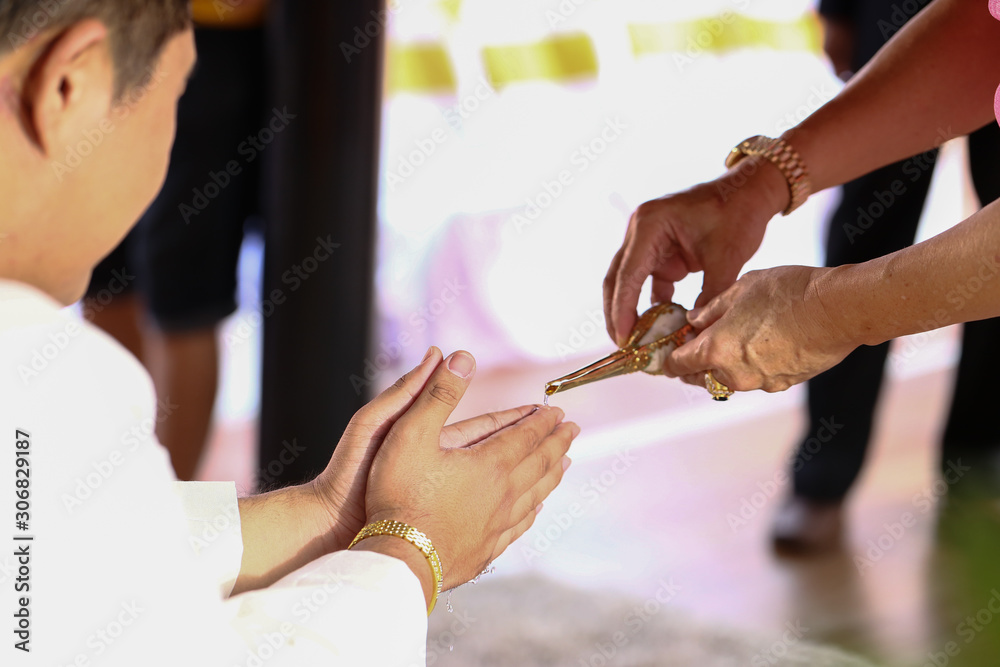 Hands pouring blessing water into bride's bands, Thai wedding.Wedding ceremony in Thailand.