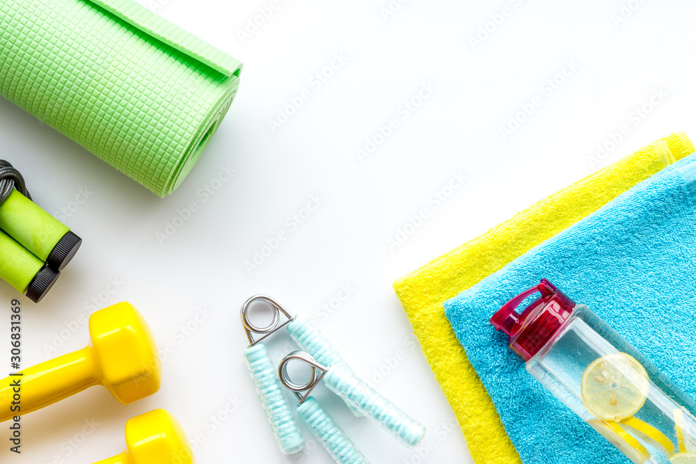 Gym equipment - dumbbells, jump rope - frame on white background top-down copy space Gym equipment - dumbbells, jump rope - frame on white background top-down copy space