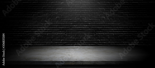 Studio dark room black brick wall with concrete shelf table for product showing.