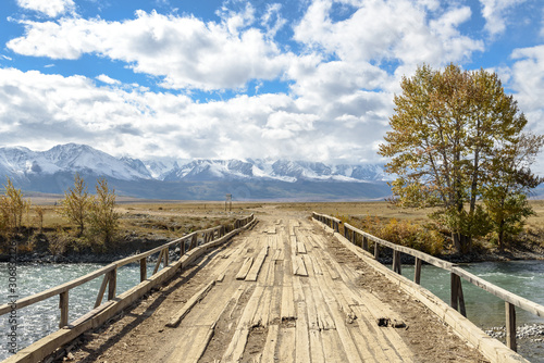 wooden bridge over a mountain river © Пучков Михаил
