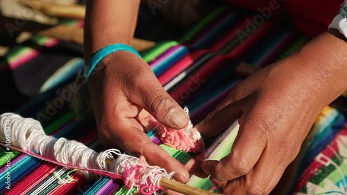 local weaver working in a colorful piece photo