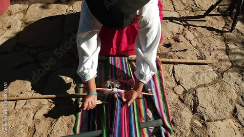woman weaving a colorful loom photo
