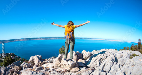 Girl on the background of the sea and mountains.