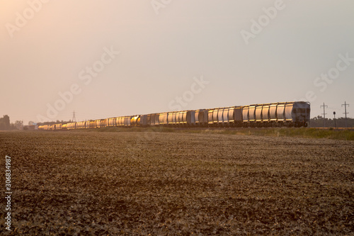 Freight Train Under Golden Sunrise on the Prairie