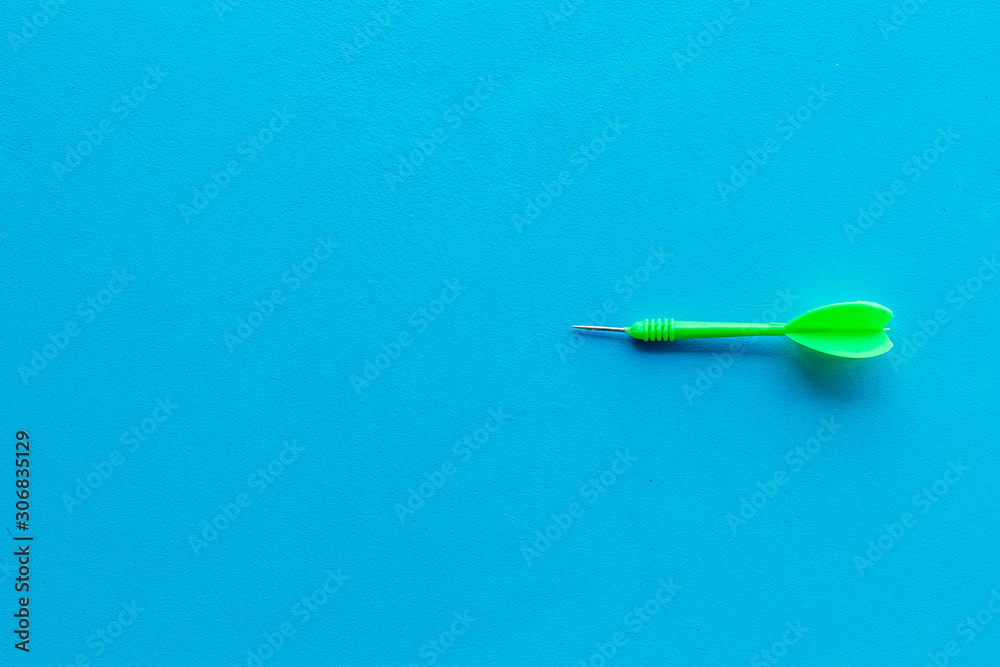 Plastic dart or arrows for darts game on blue background top view copy space Plastic dart or arrows for darts game on blue background top view copy space