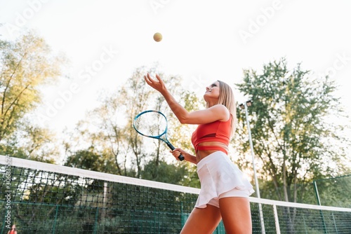 smiling young sporty girl playing tennis © Serhii