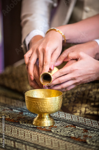 libation, Thai engagement, pour water in Thai wedding, pouring water in Thai wedding