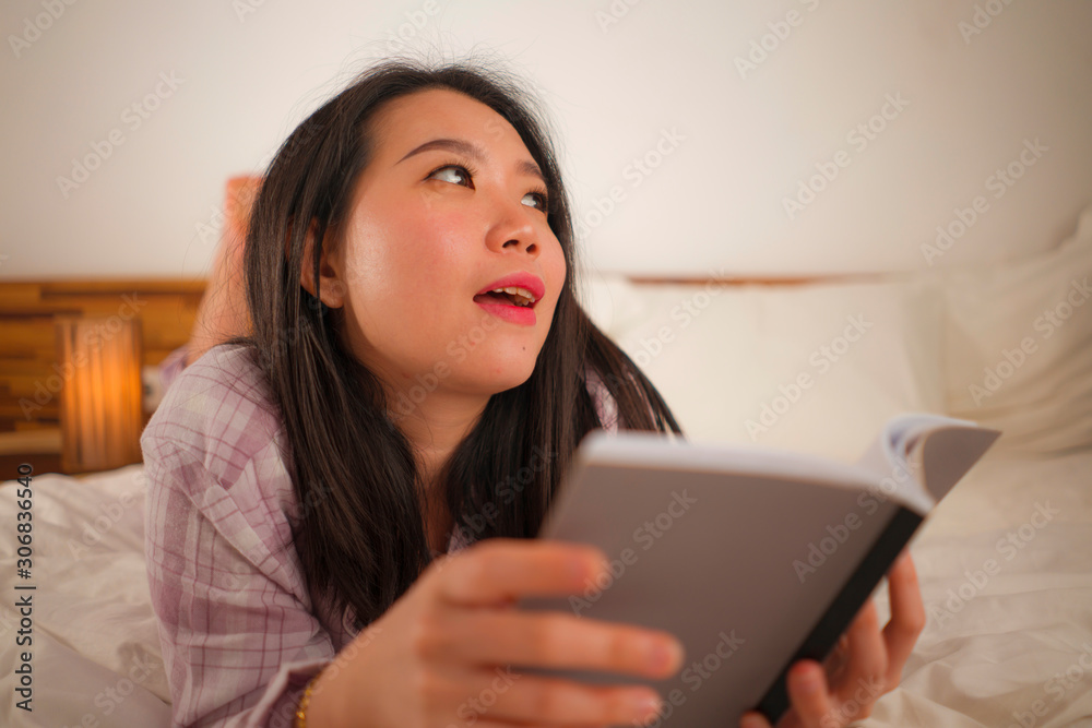 young beautiful and sweet Asian Chinese woman in bed reading book novel feeling happy and relaxed or studying at home wearing cute pajamas looking cozy and homey young beautiful and sweet Asian Chinese woman in bed reading book novel feeling happy and relaxed or studying at home wearing cute pajamas looking cozy and homey