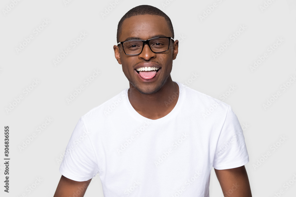 Funny smiling African American man in glasses showing tongue Funny smiling African American man in glasses showing tongue