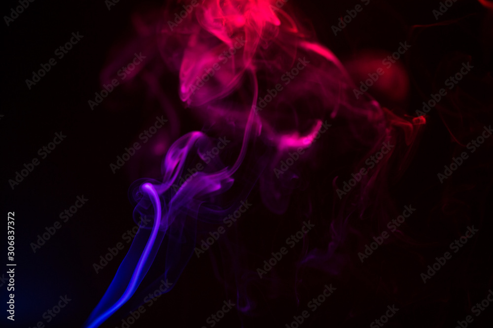 Fototapeta premium Colorful smoke close-up on a black background