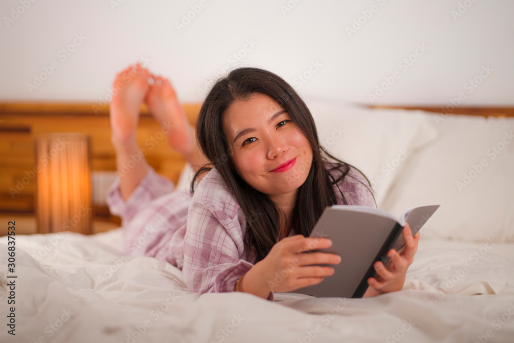 young beautiful and sweet Asian Korean woman in bed reading book novel feeling happy and relaxed or studying at home wearing cute pajamas cozy and homey young beautiful and sweet Asian Korean woman in bed reading book novel feeling happy and relaxed or studying at home wearing cute pajamas cozy and homey