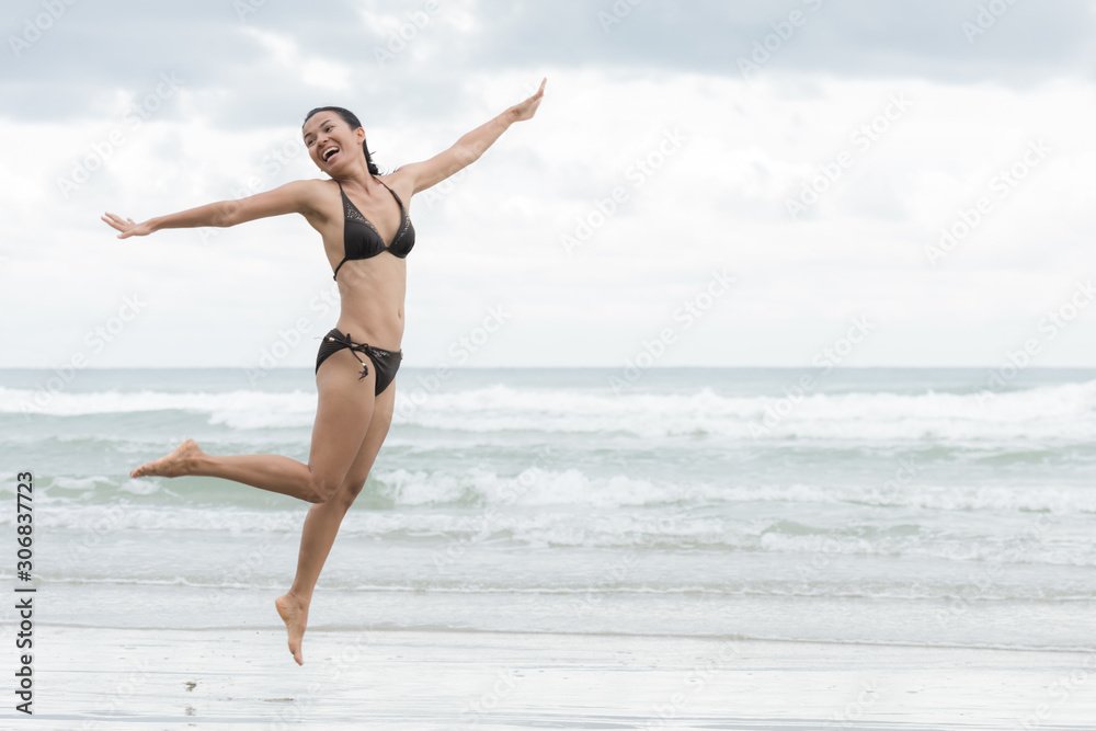 Pretty woman jumping on the beach Pretty woman jumping on the beach